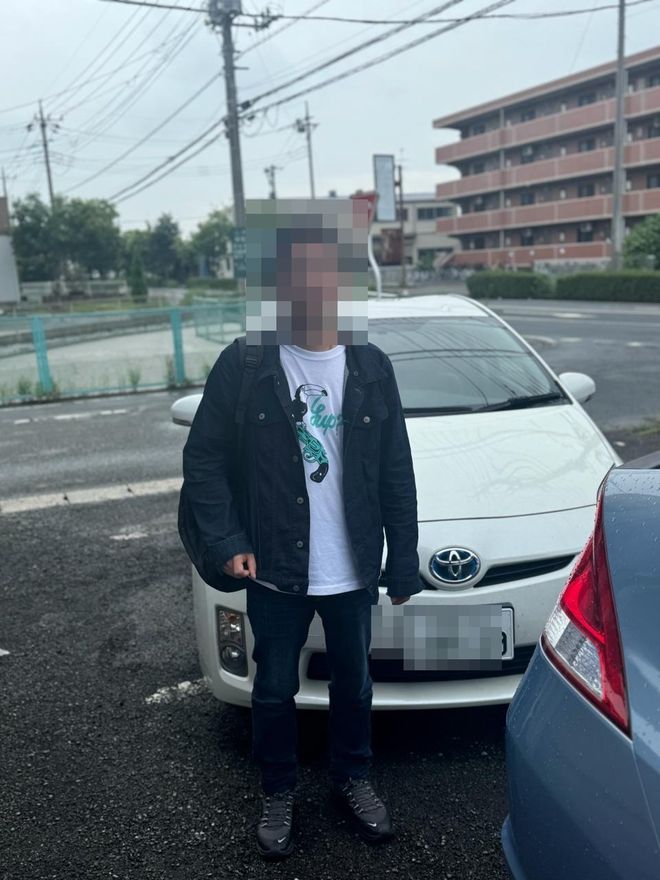 Delivered Toyota compact — face and plate blurred for privacy