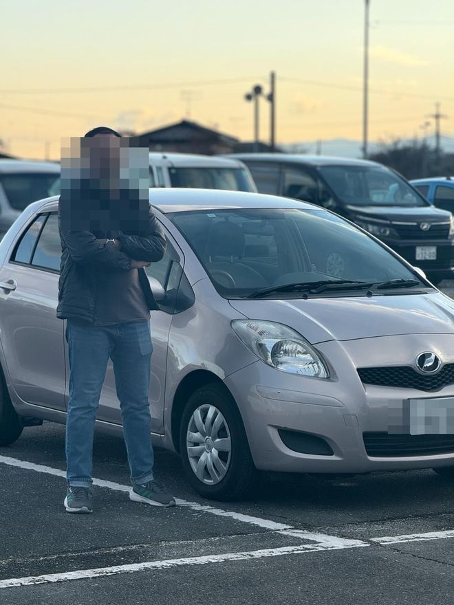 Delivered Toyota compact — face and plate blurred for privacy