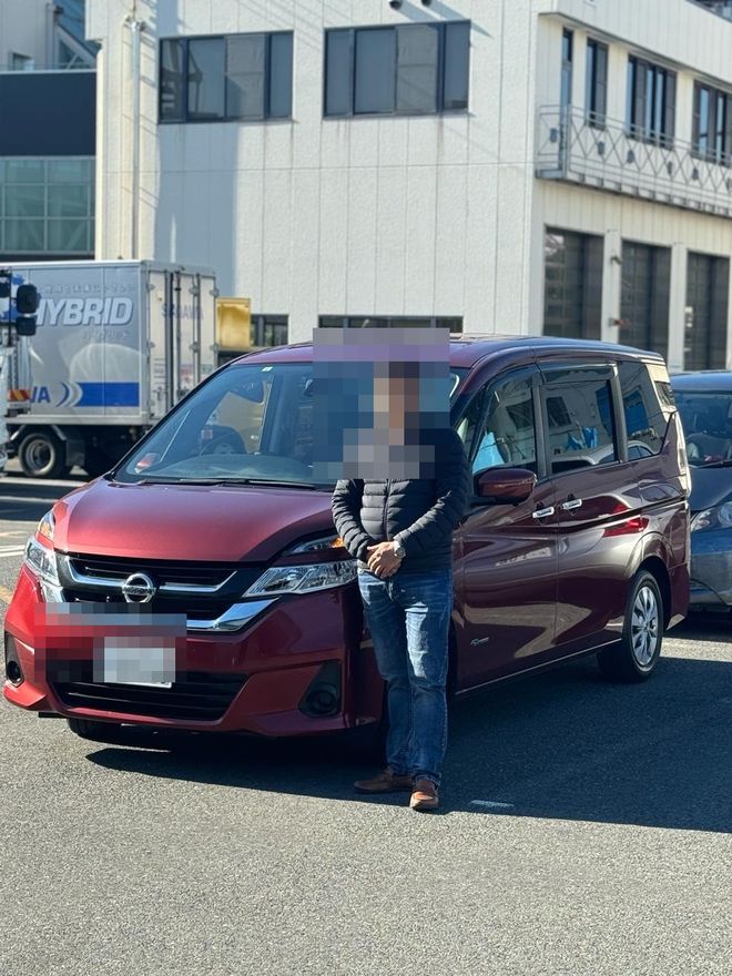 Delivered Mazda minivan — face and plate blurred for privacy