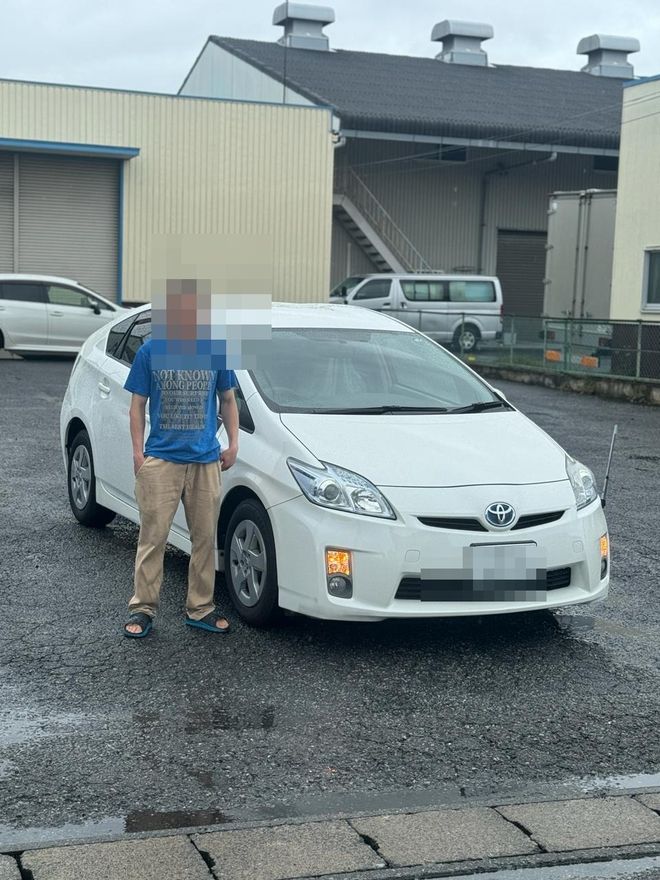 Delivered Toyota Prius — face and plate blurred for privacy